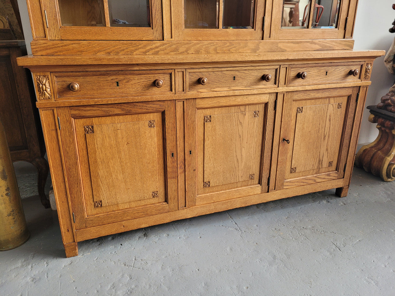 Edwardian Oak dwarf bookcase with six cupboards and three drawers. In very good original detailed condition.