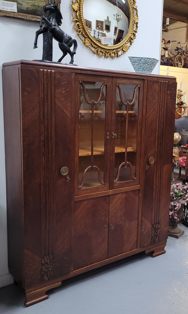 Stylish French Art Deco Oak bookcase with heaps of storage space and shelves. Middle section has two glass display doors. In good original detailed condition.