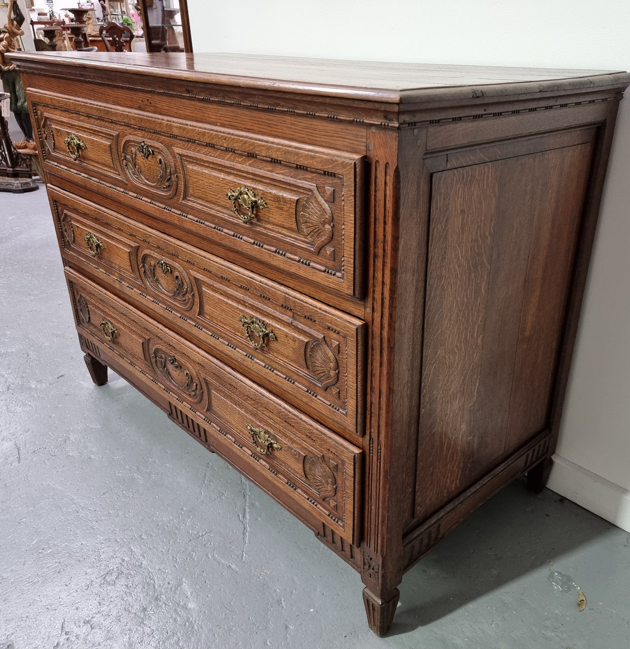 Early 19th Century French Oak chest of three drawers. It has beautiful handles and carvings. It is in good original detailed condition.