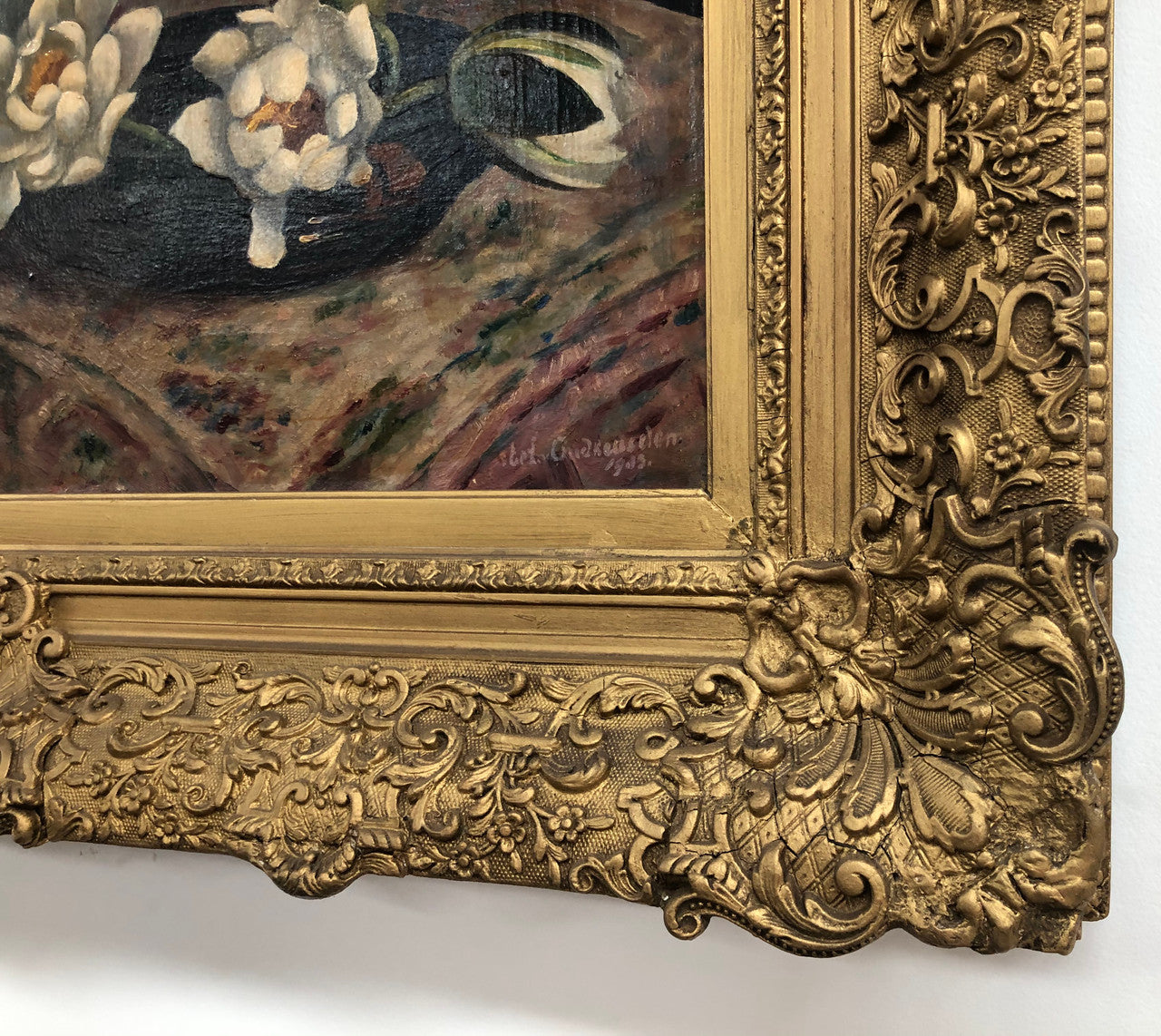 An Antique gilt-framed oil painting of floral still life. Housed in a double sweep gilt frame, signed and dated in good condition.