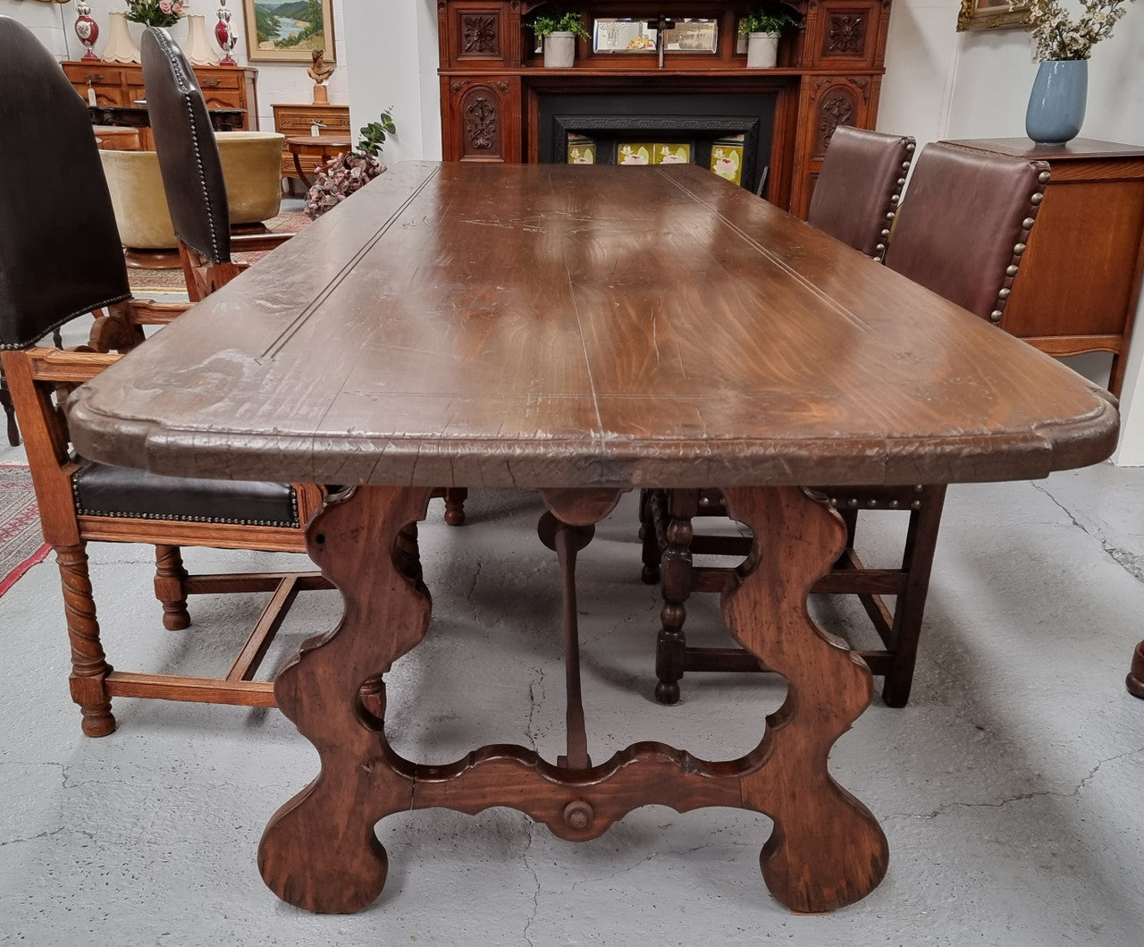 Amazing hard to find French Fruitwood Spanish style 3 meter dining table. Decorative iron work underneath and in good detailed original condition.