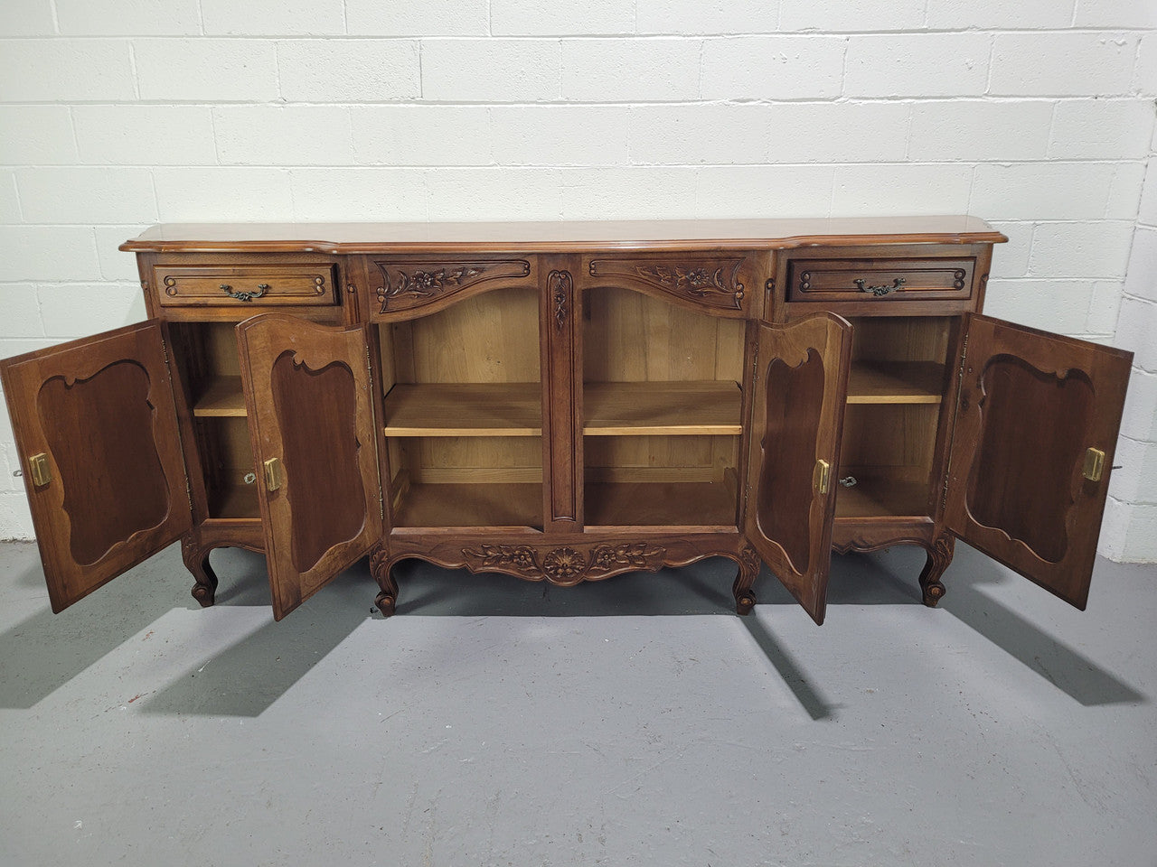 Walnut Louis XV style parquetry top four door sideboard with beautiful carving. Plenty of storage space and it is in good original detailed condition.