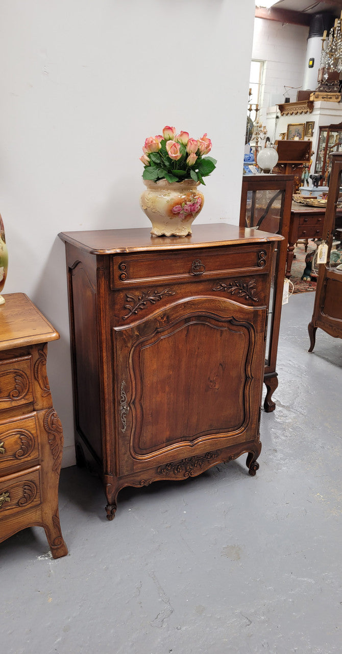 Louis 15th style walnut cupboard consisting of one drawer and two shelves. A pleasing unit with charming carvings. Circa: 1920's. In good original detailed condition.