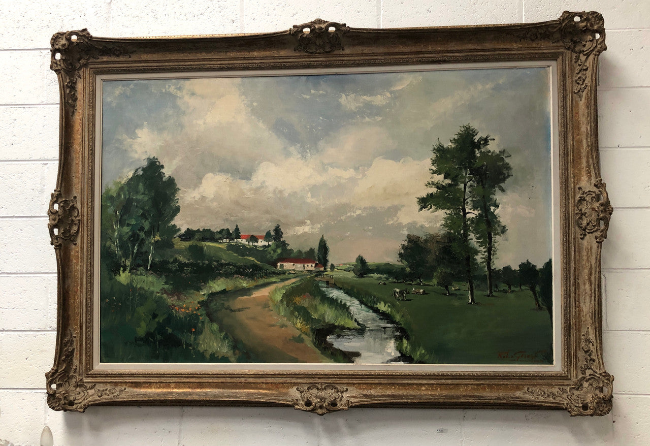Lovely framed French signed oil on canvas of a country scene in a ornate decorative frame and is in good original condition.