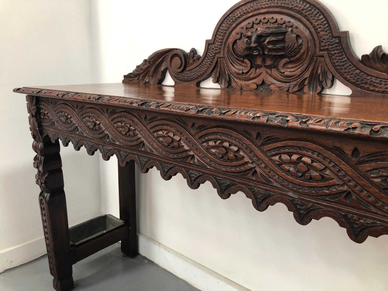 Superb 19th Century Gothic style hall/console table. It has umbrella and walking stick holders on both sides. In good original detailed condition.