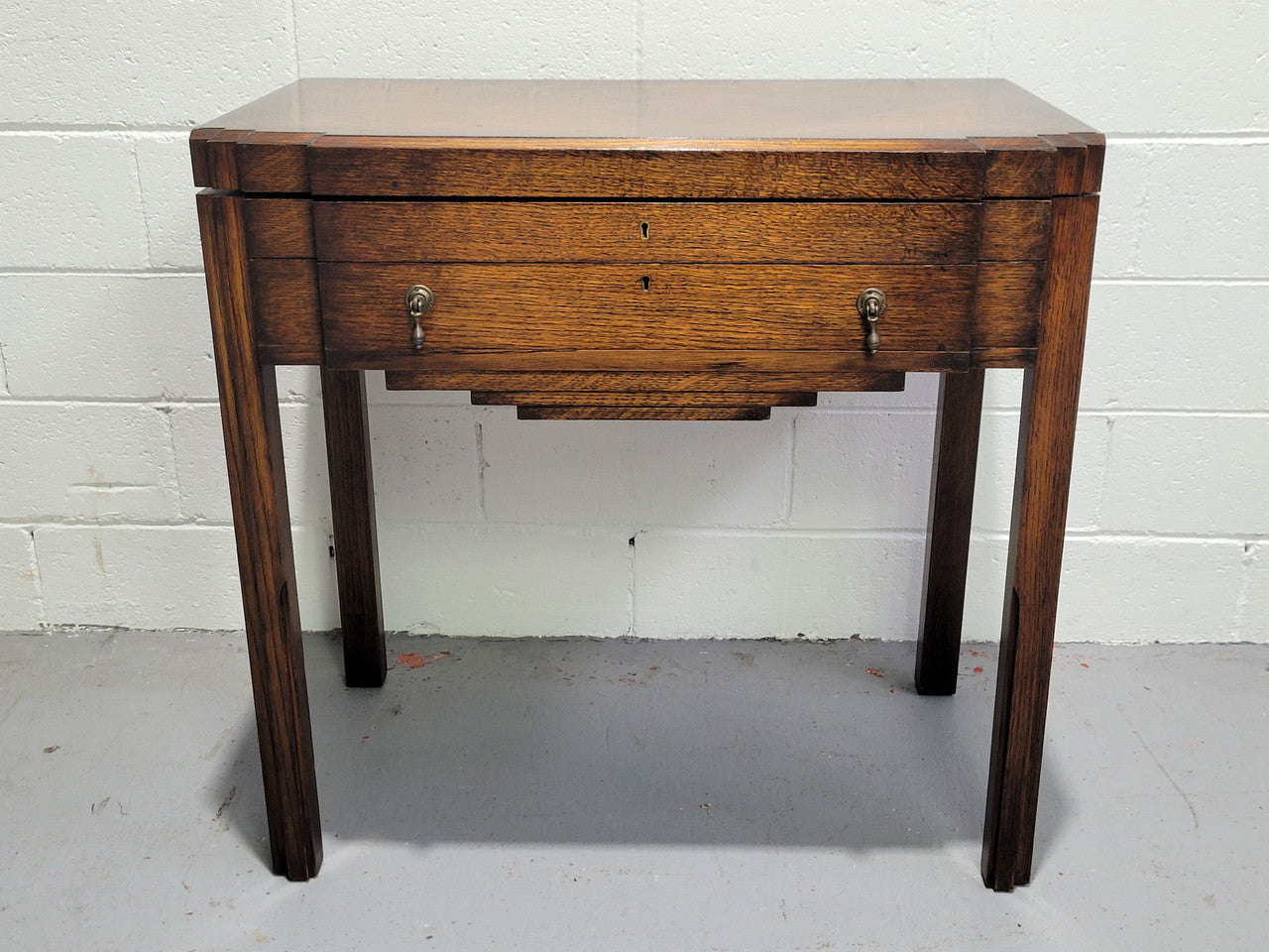 English Oak beautifully fitted cutlery table with a lift up top and drawer. Contains extensive silver plate part cutlery service by Elkington. In good original condition.
