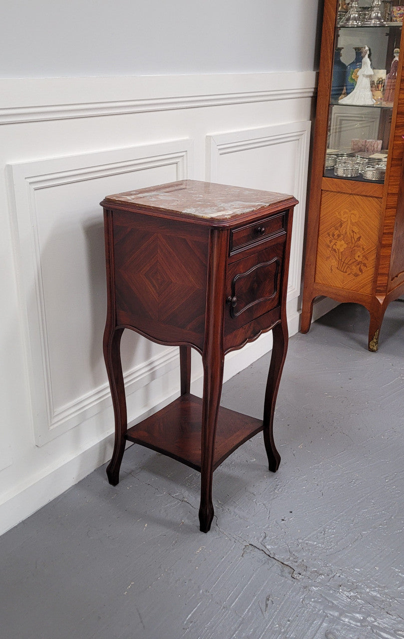 French Rosewood inset marble top single bedside cabinet with one drawer and one cupboard on elegant legs. Would also make a practical and stunning table lamp. It is in good original detailed condition.