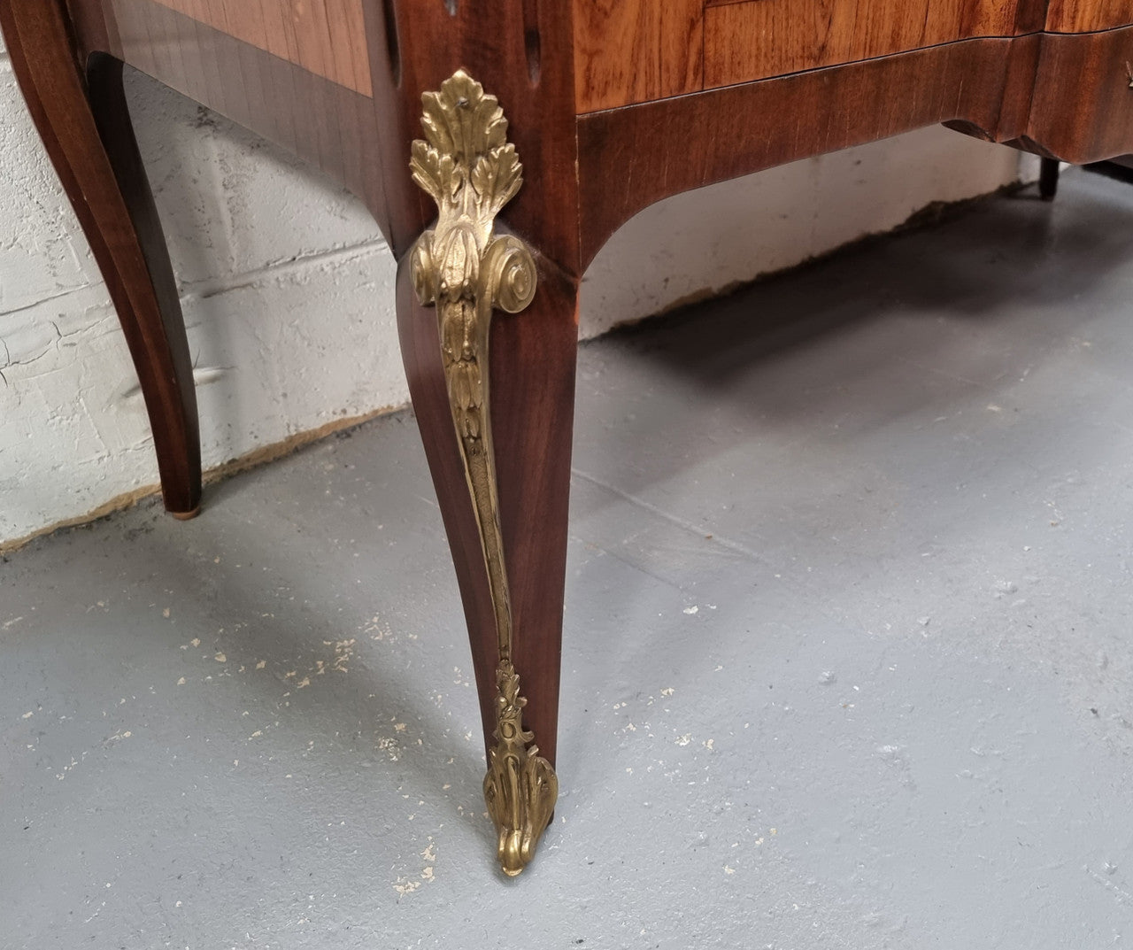 A stunning French transitional Louis XV and Louis XVI style commode. It has beautiful walnut inlay and a fabulous marble top. Comes with two drawers and fitted with gilt brass mounts. it is In very good original condition.