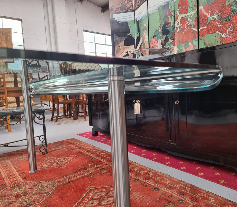 Striking and distinctive Vintage FIAM Italia Designer curved edge glass desk. FIAM was founded in 1973 by Vittorio Livio and has become synonymous with glass culture in Italy and the World. FIAM is still manufacturing today, in collaboration with various Designers, and has won numerous awards and is represented in various international museums. 
Condition: Evidence of use with minor scratches to the surface and a small chip that has been repaired. Overall, in very good condition with one repaired chip to t