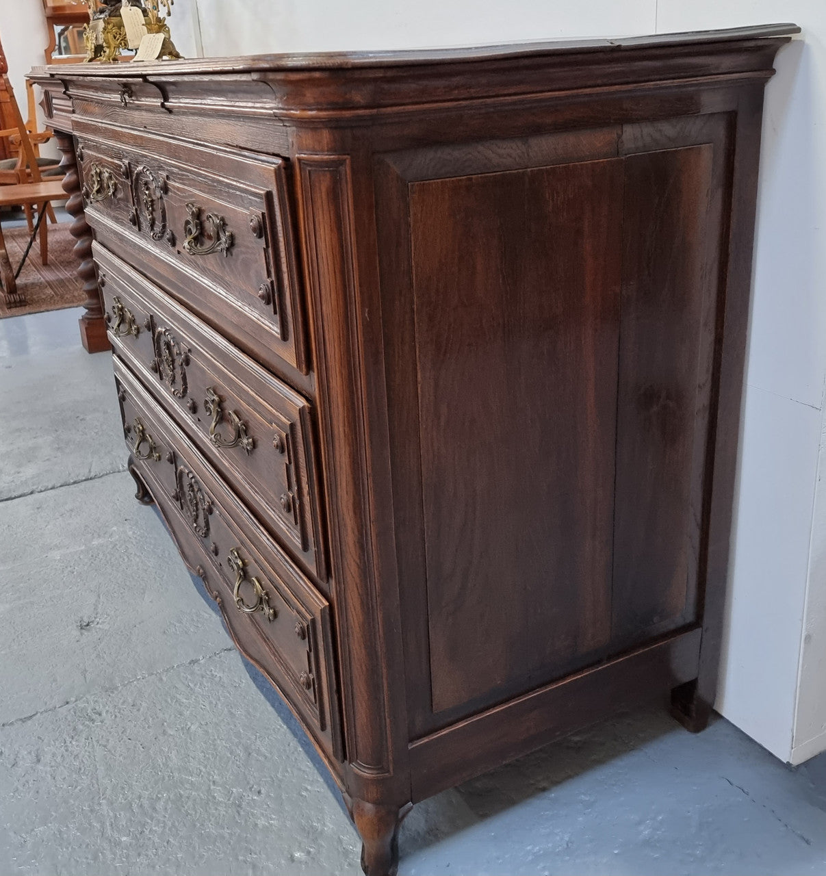 Early 19th century carved Oak three-drawer commode. Beautiful handles and has a small hidden drawer at the top. In good original detailed condition. Please note keys are not included.