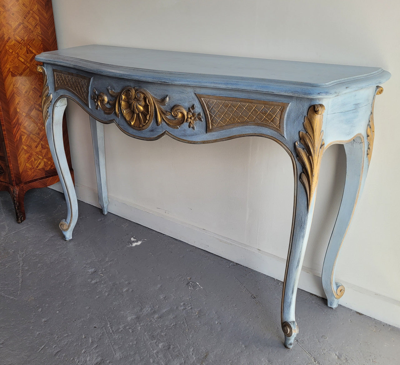 Stylish Louis 15th style console table with chalk paint and gilded highlights. They have been sourced from France and is in good original condition.