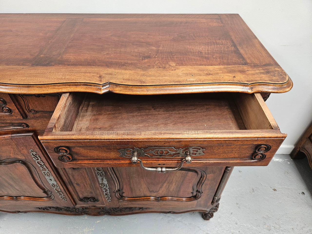 Attractive French Walnut Louis XV style two door two drawer sideboard featuring beautiful carving. Circa: 1930's. It has been sourced from France and it is in good original detailed condition.