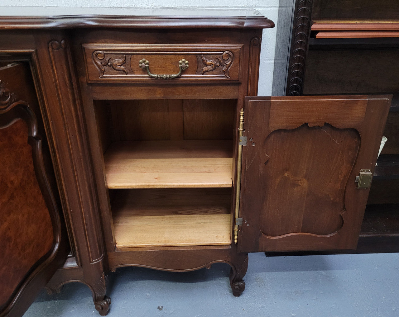 Fabulous Louis XV style French Walnut and Burr Walnut four door sideboard. Each door panel has beautiful Burr Walnut panels and open up to an adjustable shelf. Beautiful handles and two drawers for added storage. In good original detailed condition.