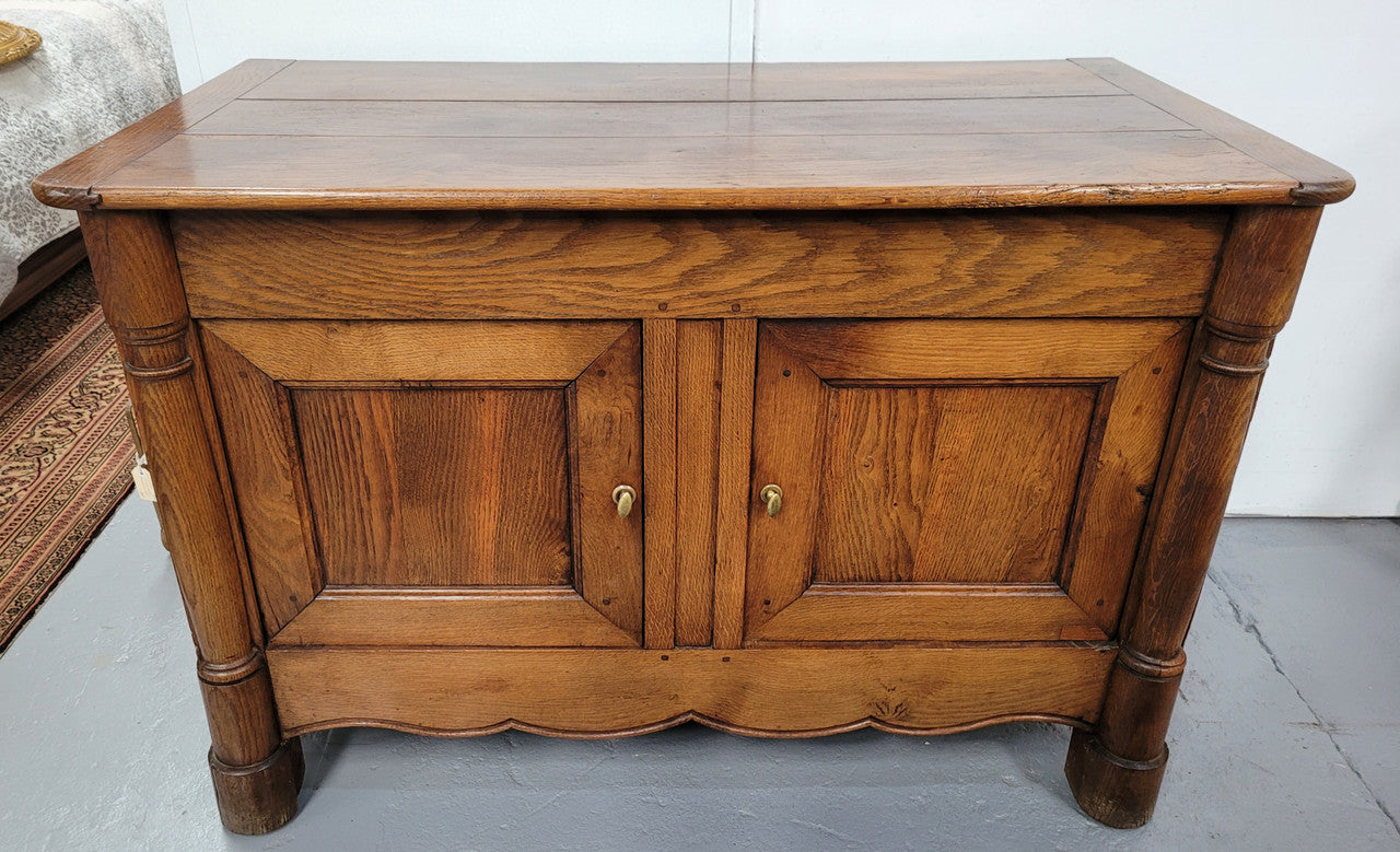 French 19th Century Oak dough bin buffet. The heavy solid top lifts upto reveal a half barrel compartment where traditionally flour and yeast were poured, mixed and proofed to grow into a nice dough.
Although originally intended for dough this would make an ideally TV cabinet with the two doors opening with plenty of storage.