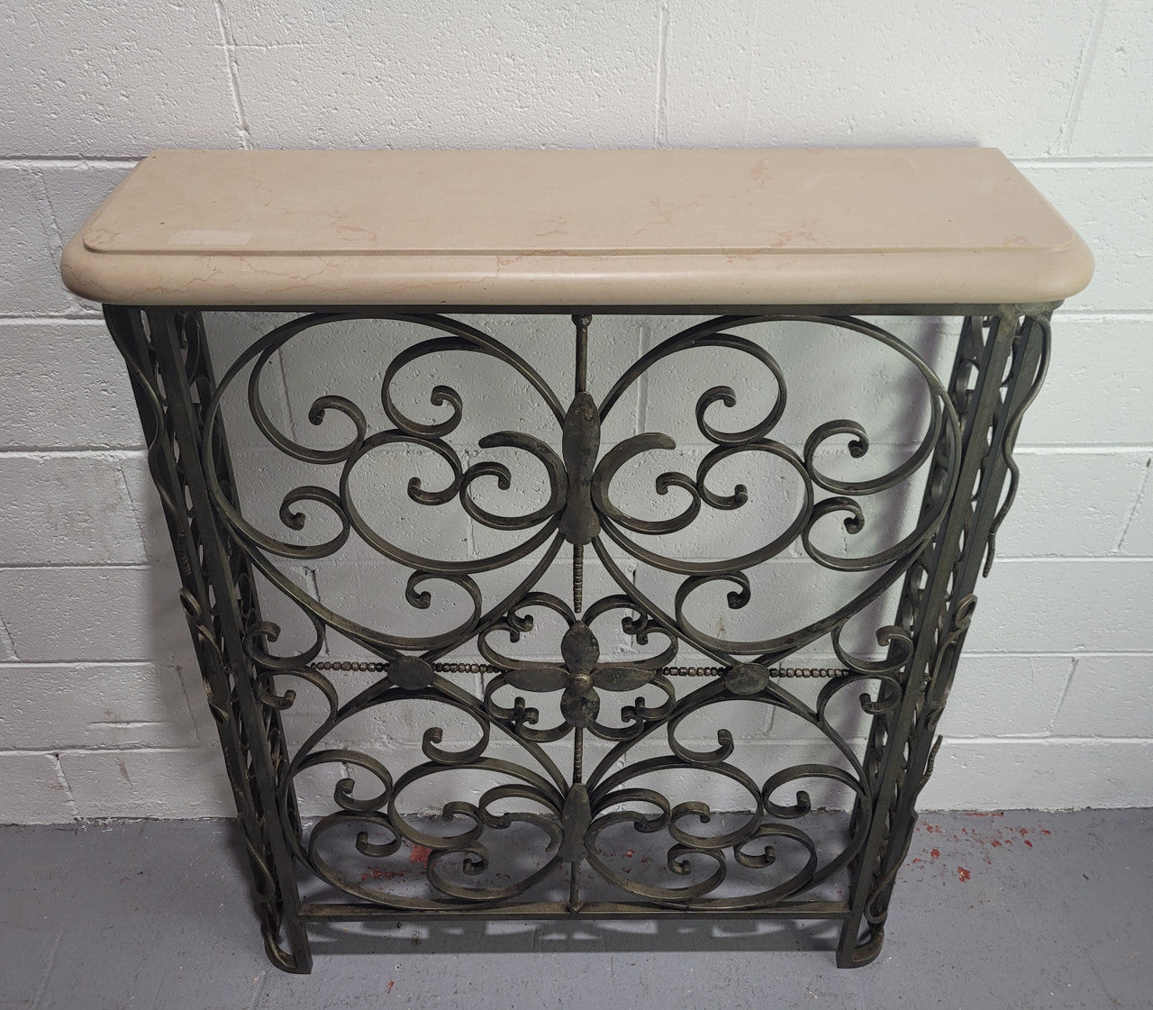 Stunning Art Deco wrought iron and marble top console table. It has amazing decorative iron work at the bottom and a beautiful marble top. It is in good original detailed condition.