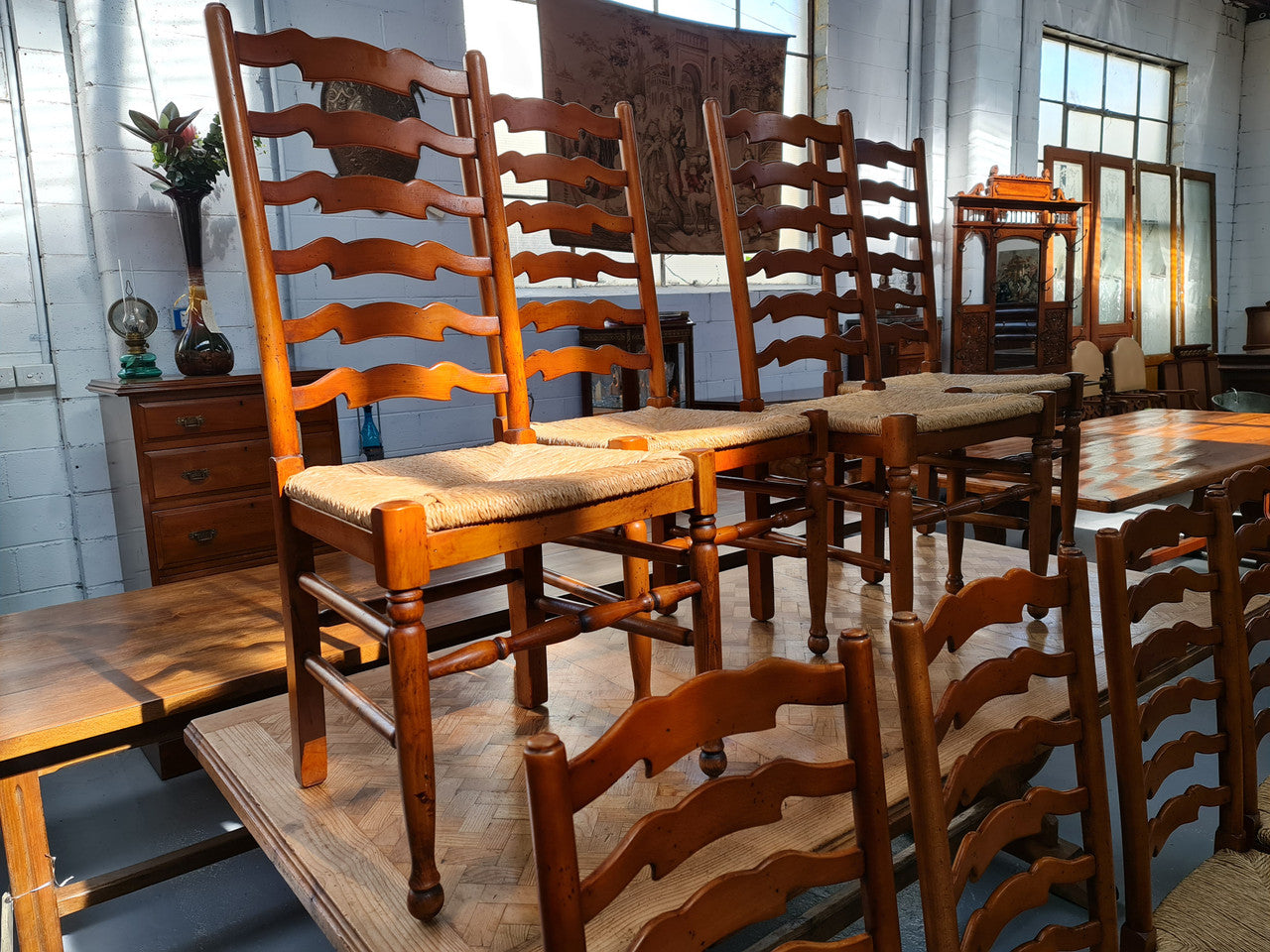 Charming set of eight Cherry Wood ladder back dining chairs. They are in good original detailed condition.