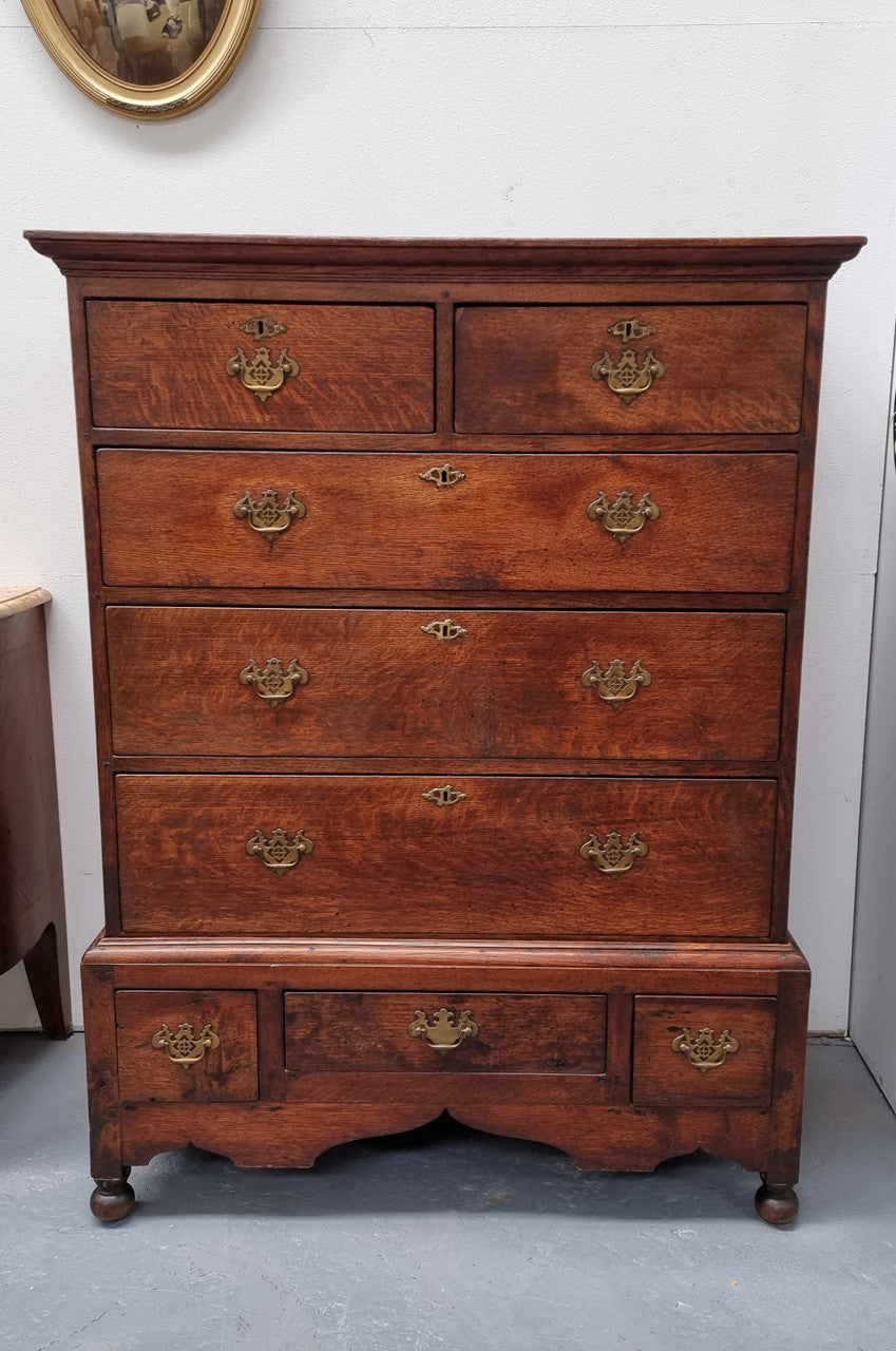 Early 19th Century English Oak chest on stand. It has been sourced in France and has plenty of storage space with eight drawers. In good original detailed condition.