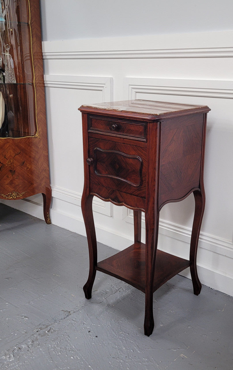 French Rosewood inset marble top single bedside cabinet with one drawer and one cupboard on elegant legs. Would also make a practical and stunning table lamp. It is in good original detailed condition.