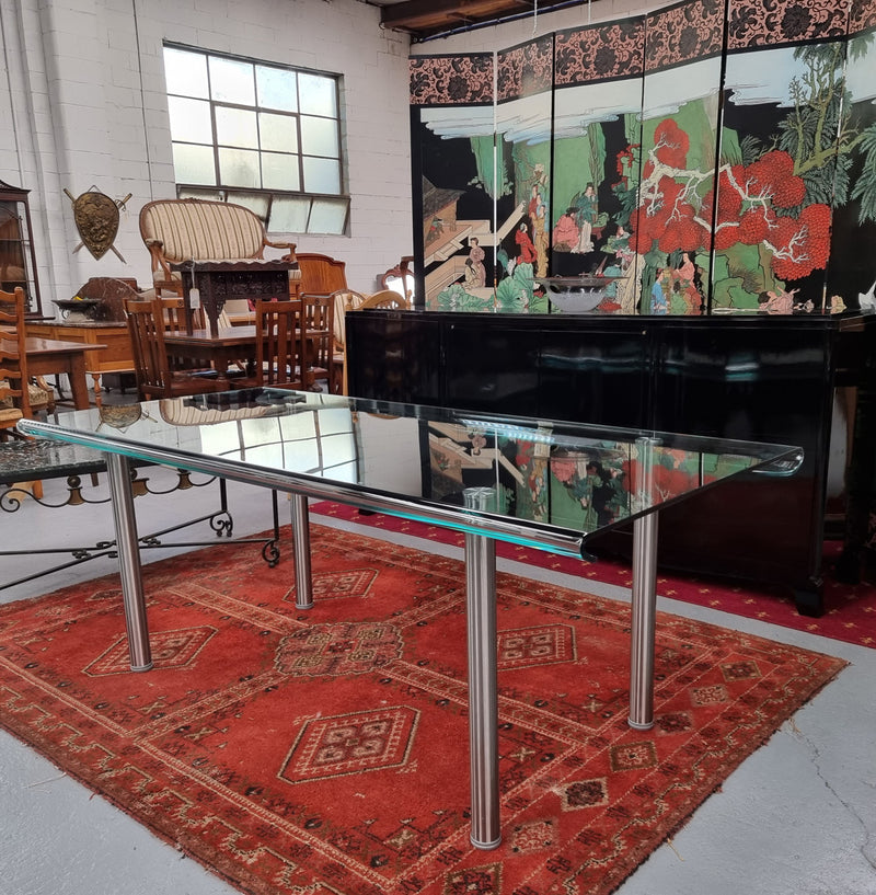 Striking and distinctive Vintage FIAM Italia Designer curved edge glass desk. FIAM was founded in 1973 by Vittorio Livio and has become synonymous with glass culture in Italy and the World. FIAM is still manufacturing today, in collaboration with various Designers, and has won numerous awards and is represented in various international museums. 
Condition: Evidence of use with minor scratches to the surface and a small chip that has been repaired. Overall, in very good condition with one repaired chip to t