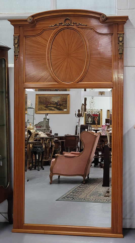 Stunning long Louis XV style satinwood Trumeau mirror decorated with Bronze ormolu mounts. It has its original bevelled mirror and it in good detailed condition. It has been sourced from France.