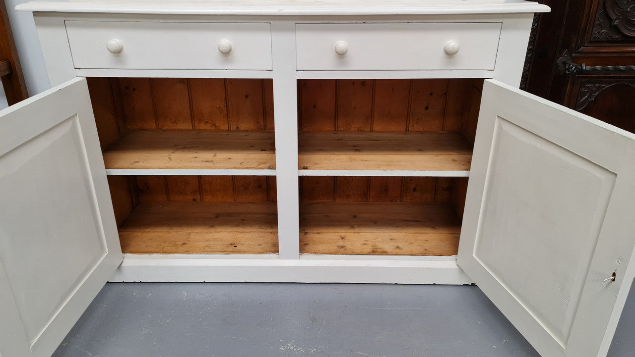 Australian painted two door kitchen hutch display and buffet cabinet. The top section has hooks and shelves. The bottom has two drawers along with cupboard space for added storage. In good original condition.