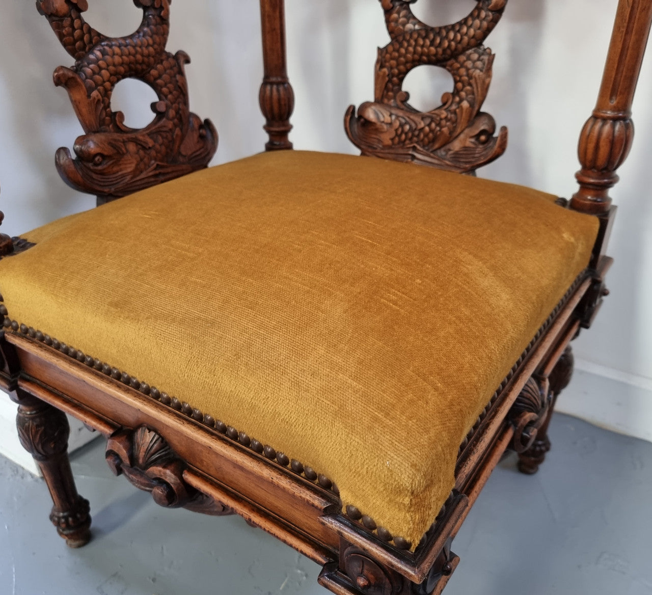 Beautifully carved French Walnut corner chair with upholstered seat. In good original detailed condition.