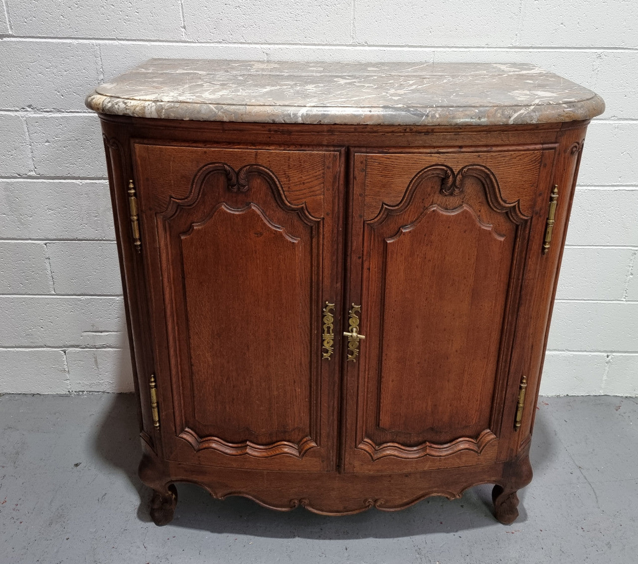 Rare 19th Century French Oak and marble top oval buffet / cabinet. Stunning thick marble top and decorative handles. In good original detailed condition.