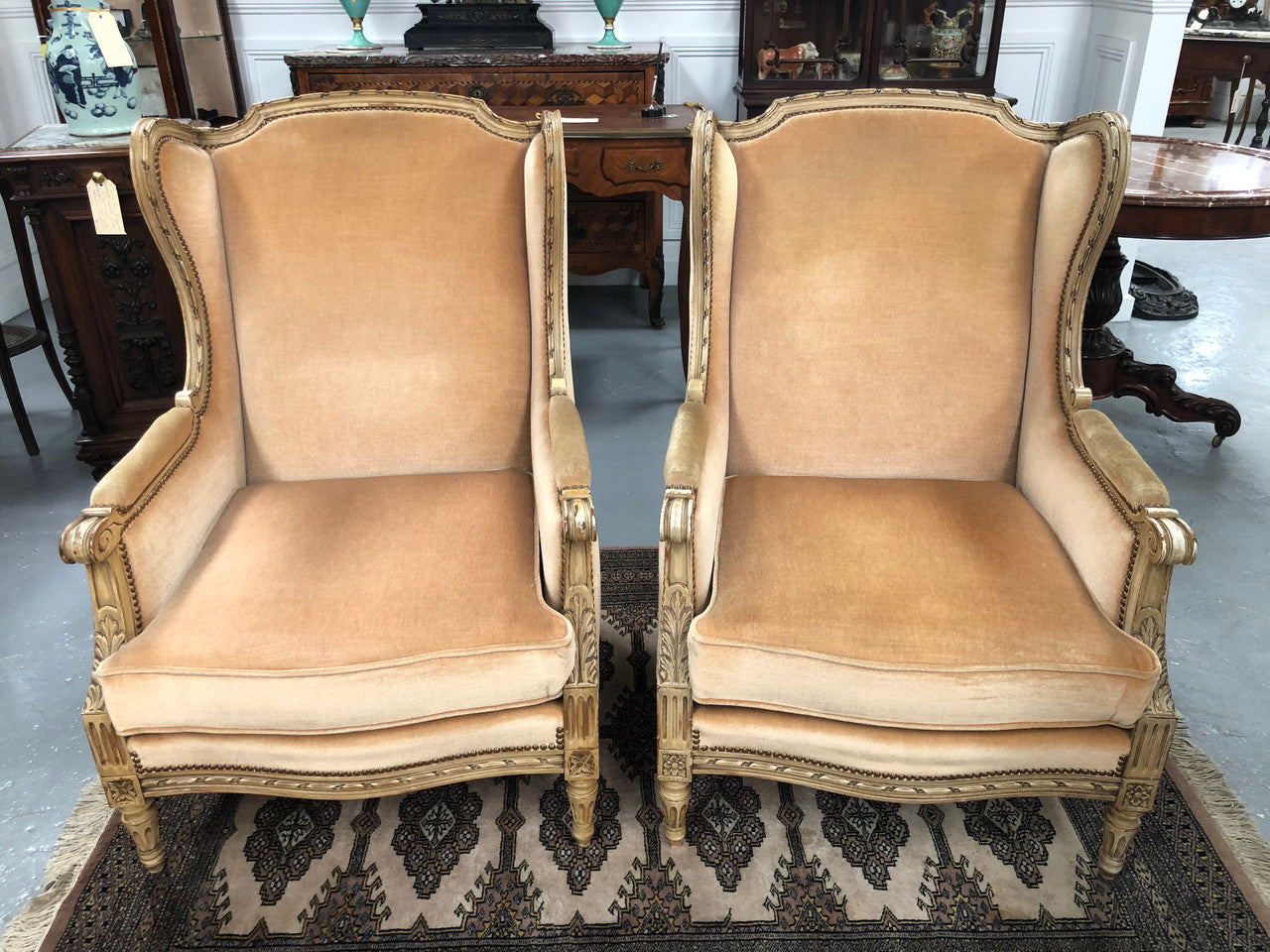 Pair of Vintage French original painted bergere wingback armchairs. The fabric is in very good original condition, please view photos as they help form part of the description. Please note the matching foot stool is being sold separately.