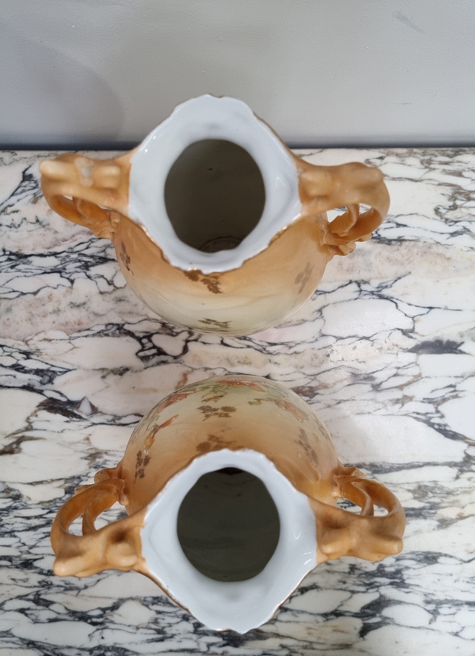 Decorative Pair of Art Nouveau Vases decorated with hand finished roses in muted tones. Gilt highlights. Impressed numbers to base. In good original condition, please view photos as they help form part of the description.
