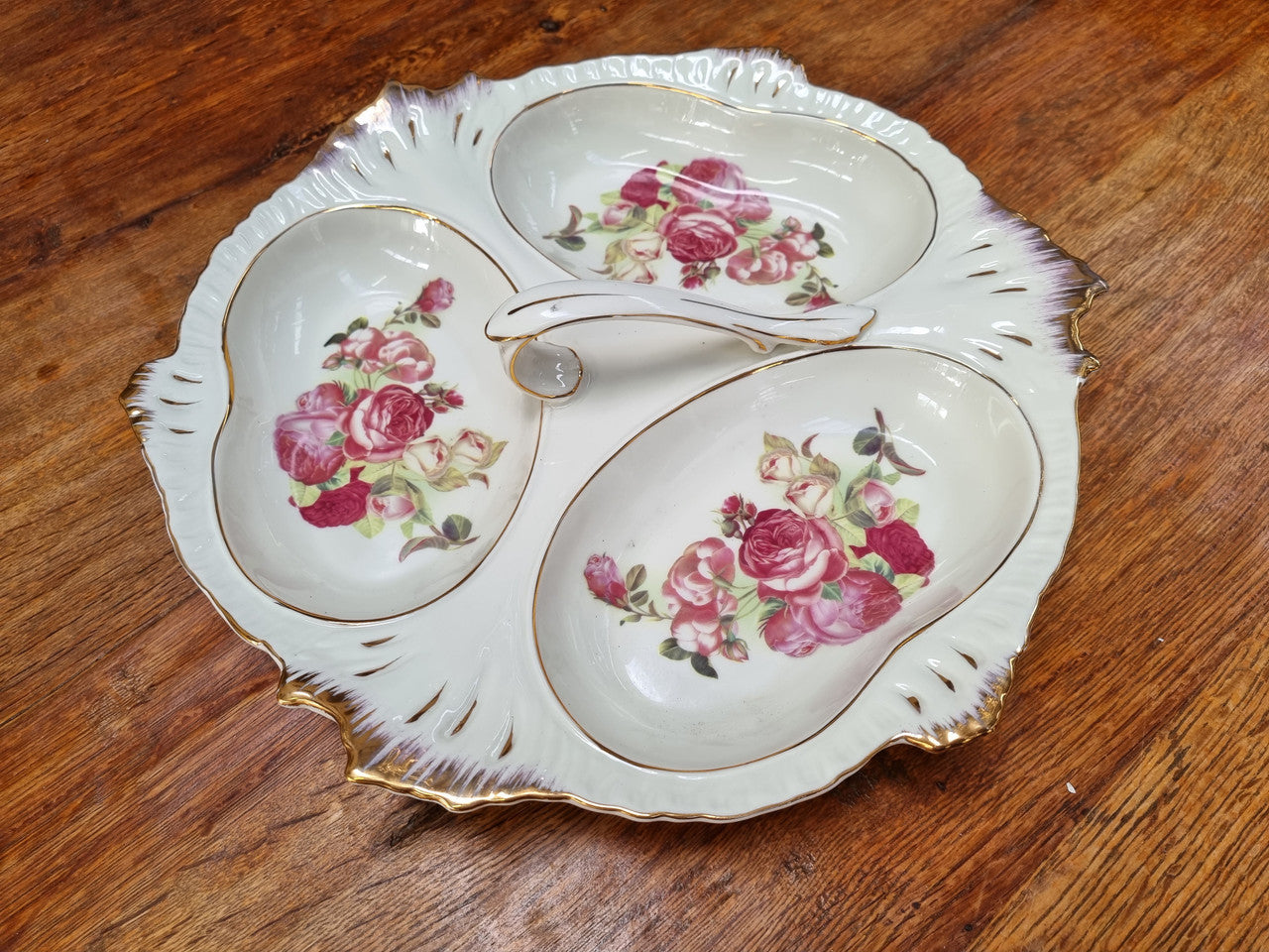Vintage ceramic three sectional floral bowl with handle and gilt rim. Stamped underneath and in good original condition with no chips or cracks. Please view photos as they help form part of the description.