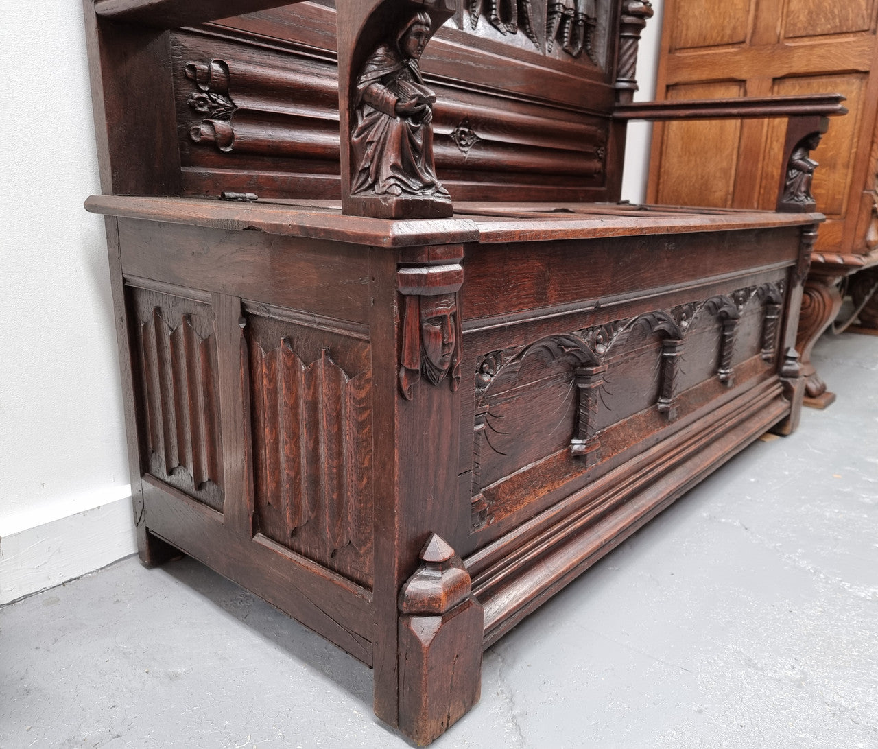 Early 19th Century French Oak Gothic style hall seat with a lift up seat. It has amazing detailed carvings and is in good original detailed condition.