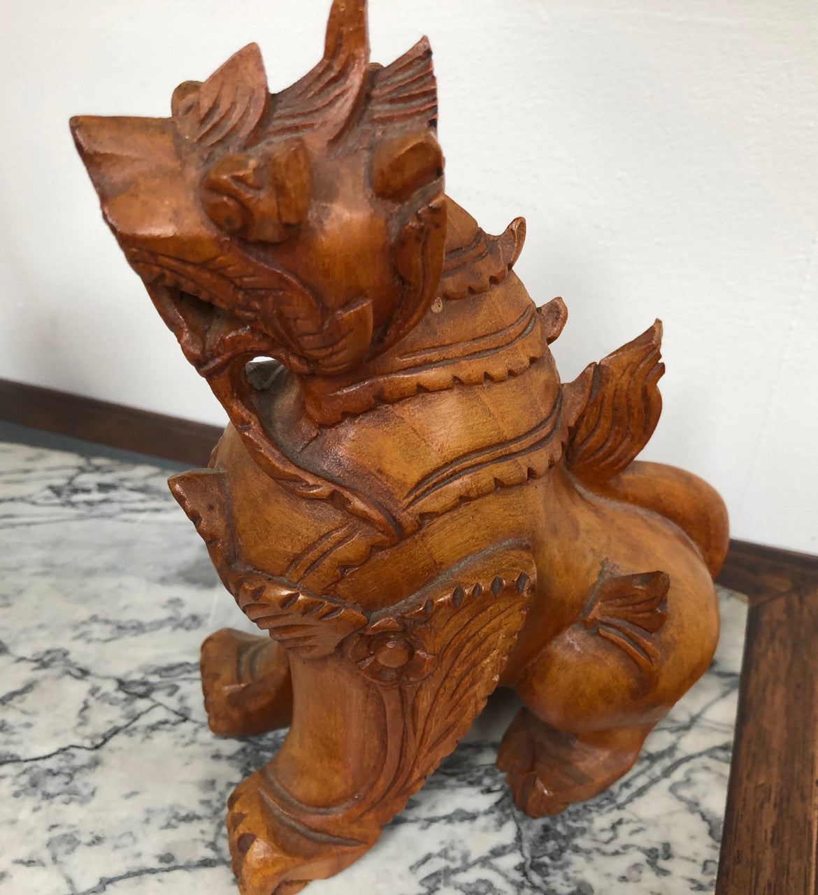 Chinese carved Teak Foo dog with very good detail. In good original condition.