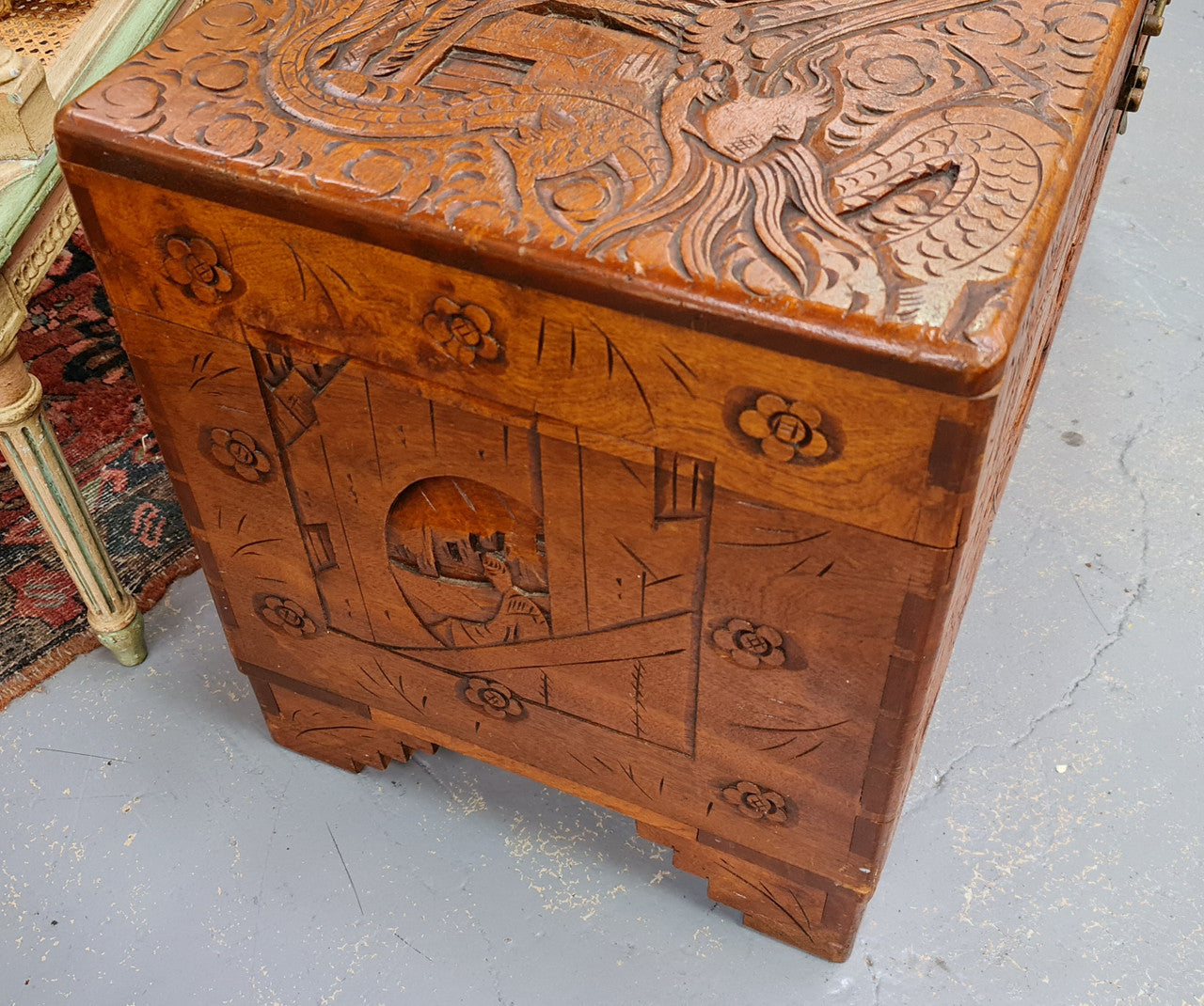 Vintage nicely carved Camphor wood chest. It has amazing carvings of boats, dragons and temples. It is in good original detailed condition.