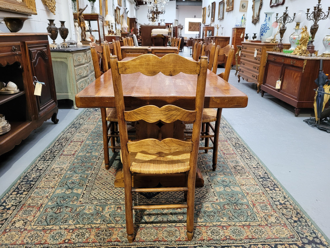 French Farmhouse table with a beautiful thick plank top and stretcher base. Can seat 8-10 people comfortably and is in good original detailed condition.