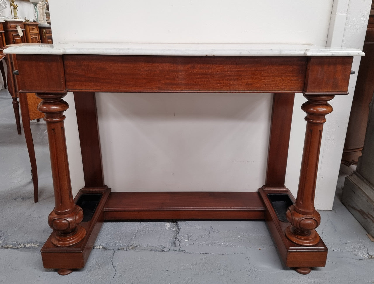 Classic Victorian mahogany console table with white marble top, one drawer and accommodation for sticks/umbrellas. In good original detailed condition.