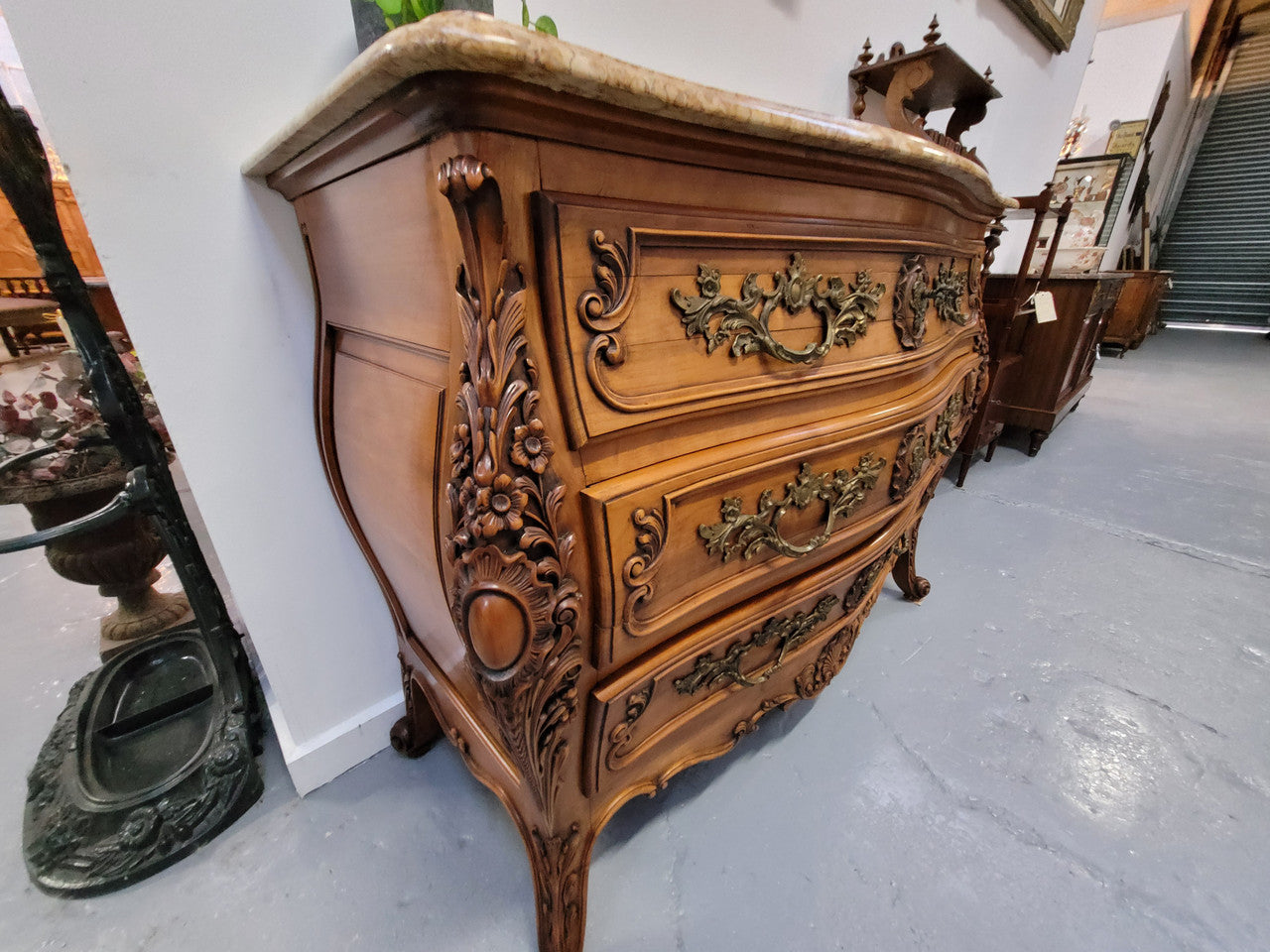 Impressive Louis XV style three drawer walnut commode. Ormolu handles and bevelled marble top complimenting detailed carving. In very good original detailed condition.