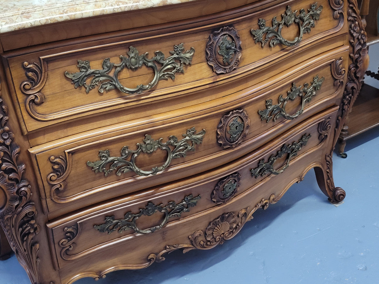 Impressive Louis XV style three drawer walnut commode. Ormolu handles and bevelled marble top complimenting detailed carving. In very good original detailed condition.