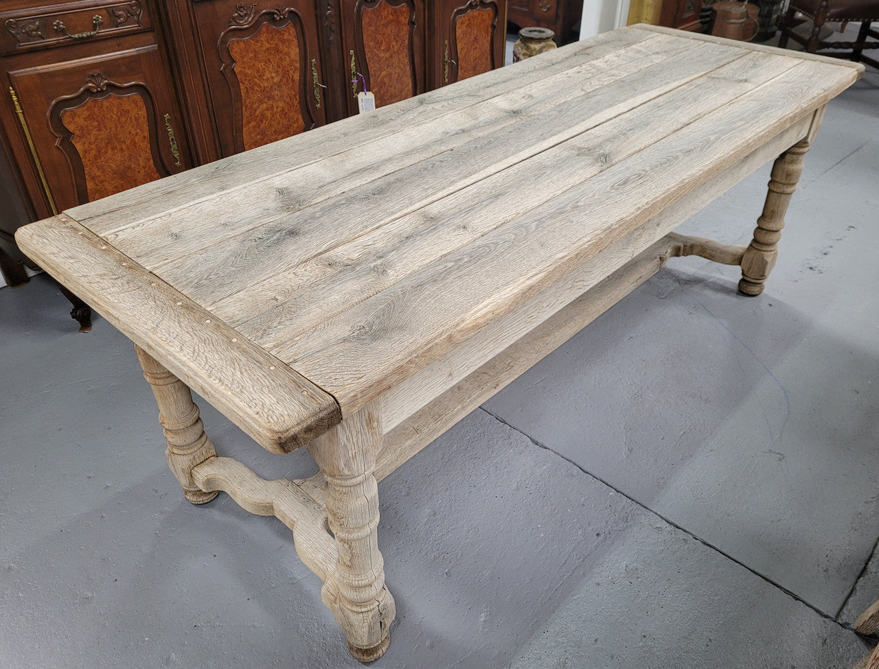 French stripped Oak pedestal stretcher base Farmhouse table with two drawers on either side of table. Features raw wood that could be used as is for a distressed look, or finished and waxed for a more refined look.