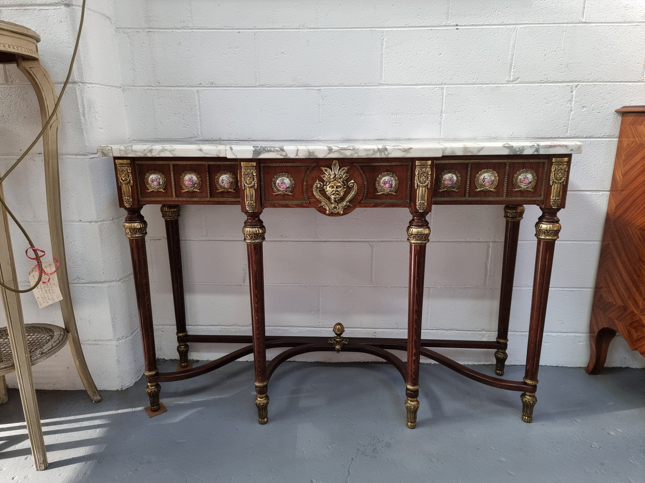 Vintage Mahogany marble top console table with matching mirror. Both with inset limoge panels surrounded by gilt brass. Highly decorative and in good original detailed condition. Circa 1950.