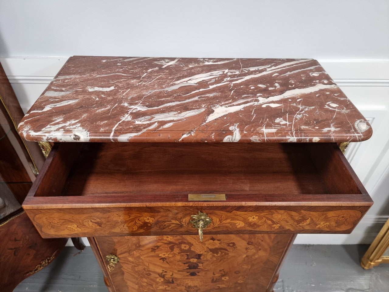 Elegant French transitional style Walnut & Kingwood Salon cabinet. It has beautiful marquetry inlay, a marble top and decorative ormolu mounts. Sourced From France and is in good original detailed condition.