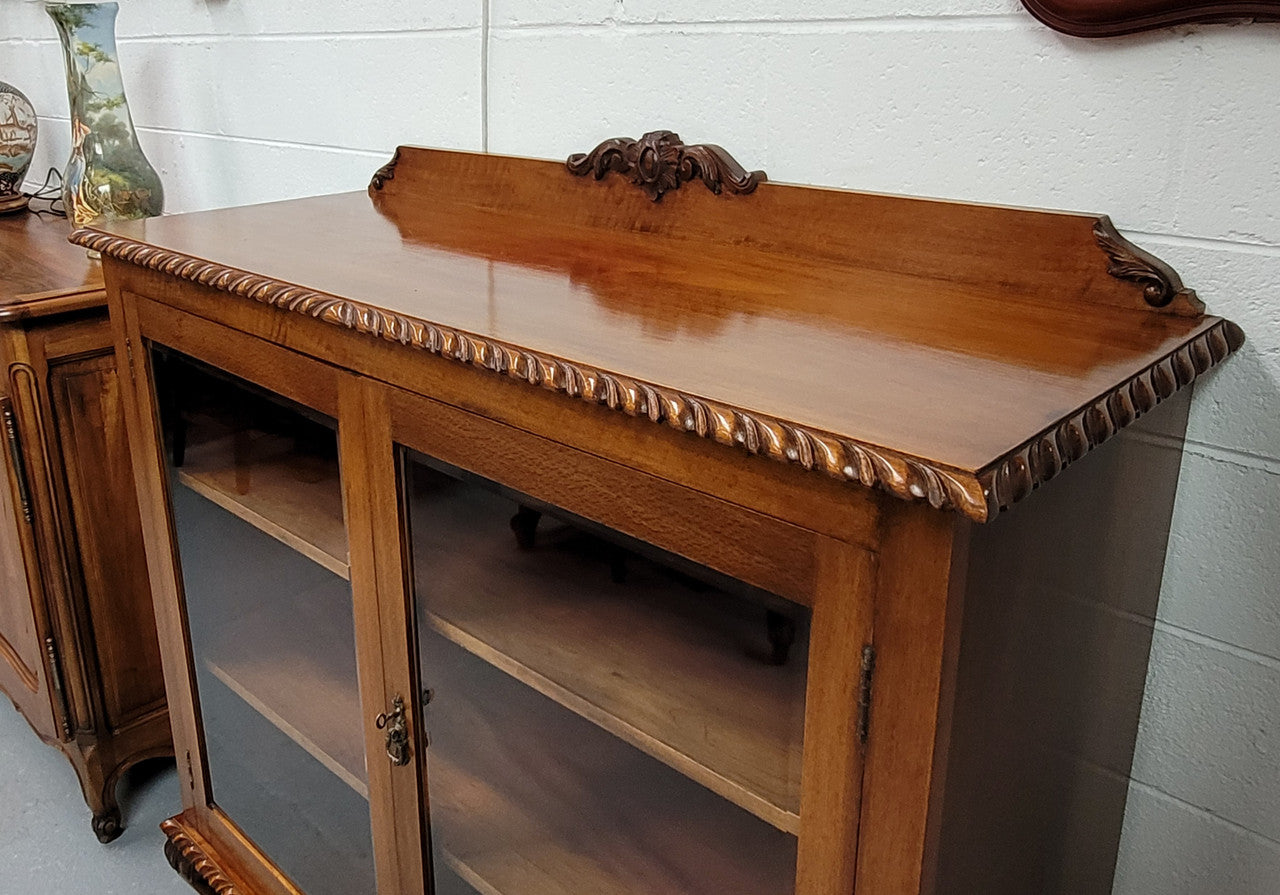 Chippendale style Mahogany two door bookcase. It has bevelled glass doors and two adjustable shelves. It has been sourced locally and is in good original detailed condition.
