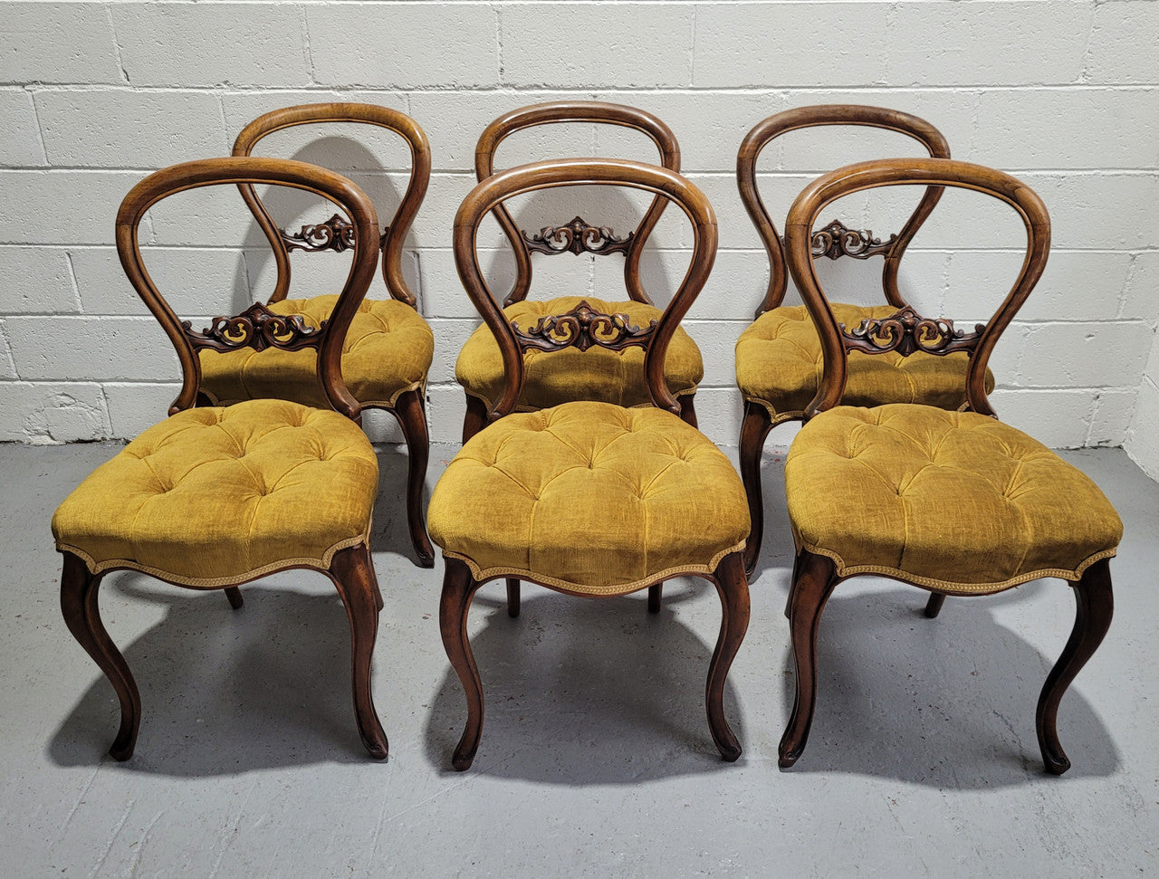 Set of six upholstered Victorian balloon back chairs. In good original detailed condition.
