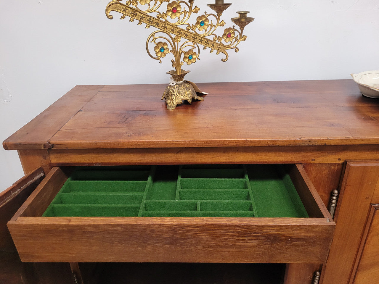 Early 19th Century Louis XV style Fruitwood three door sideboard. It has three hidden internal drawers and one of them has green valet and small sections for cutlery. It is in good restored condition.