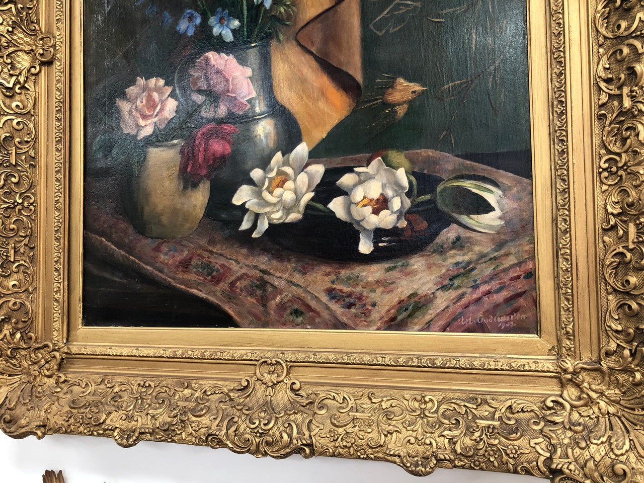 An Antique gilt-framed oil painting of floral still life. Housed in a double sweep gilt frame, signed and dated in good condition.