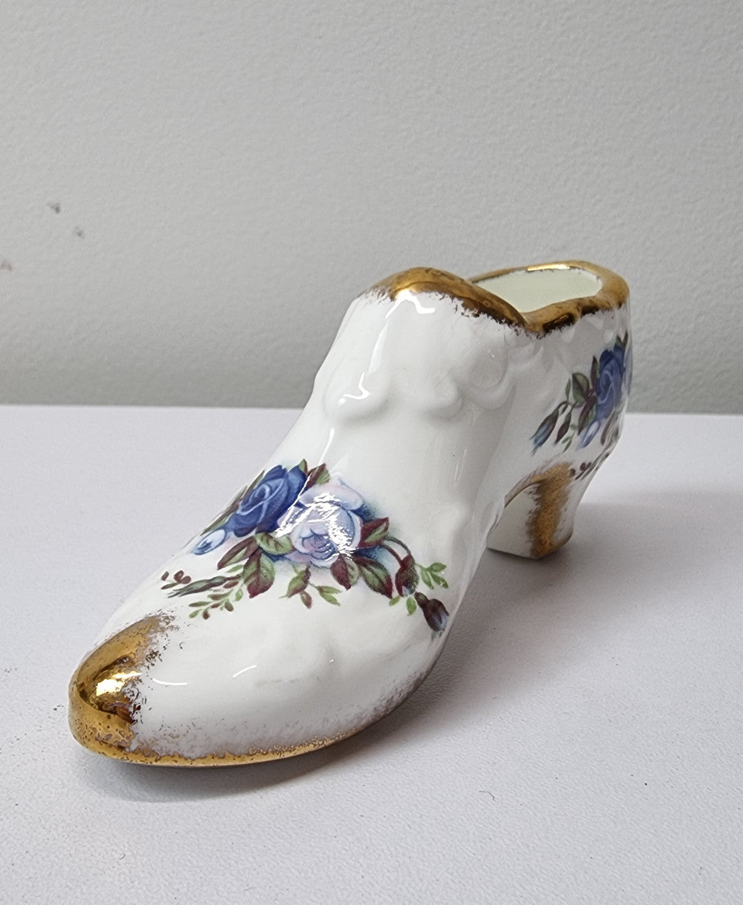 A lovely pair of Royal Albert China shoes in good original condition. Stamped on the sole 'Moonlight Rose: Royal Albert Bone China, England ©1987.