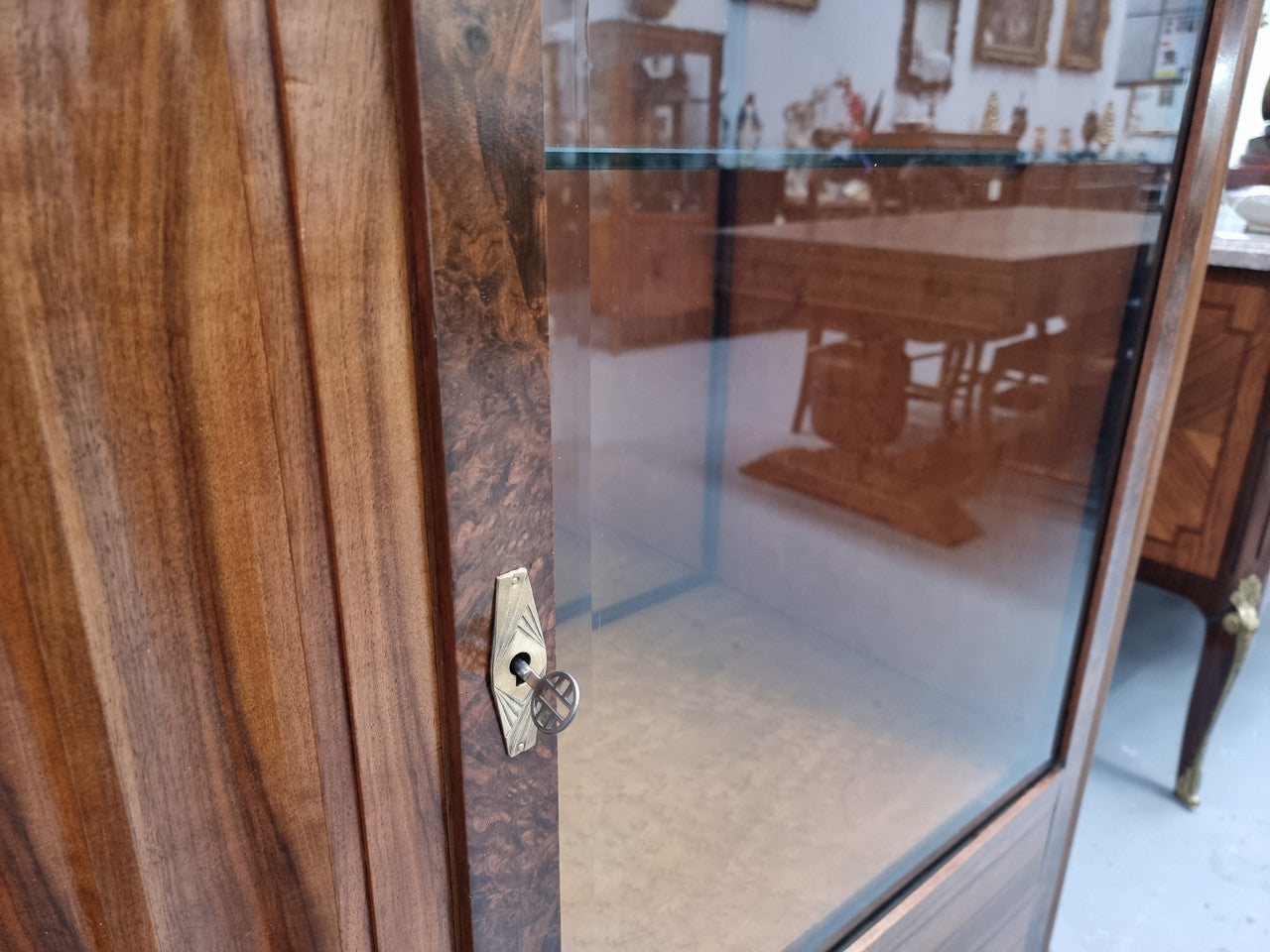 Stunning French Art Deco figured Walnut with Portoro marble top cocktail cabinet. Features chrome trim on base and glass display in door. It is in fully restored condition.