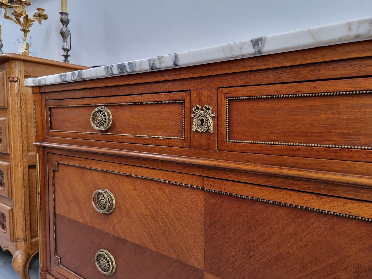 Louis XVI style Mahogany marble top cupboard. It has two drawers at the top and two doors at the bottom all with decorative handles and mounts. Stunning white marble top and all in good original detailed condition.