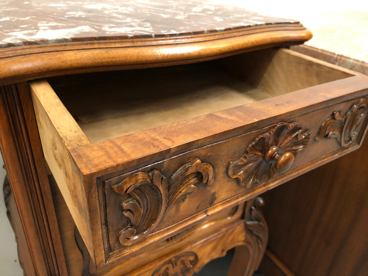 Single French carved bedside with inset marble top. It has beautiful carving and a drawer and cupboard for storage. In very good original detailed condition.