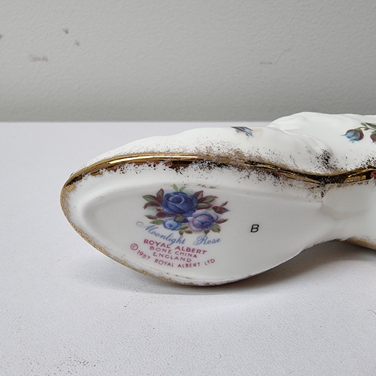 A lovely pair of Royal Albert China shoes in good original condition. Stamped on the sole 'Moonlight Rose: Royal Albert Bone China, England ©1987.