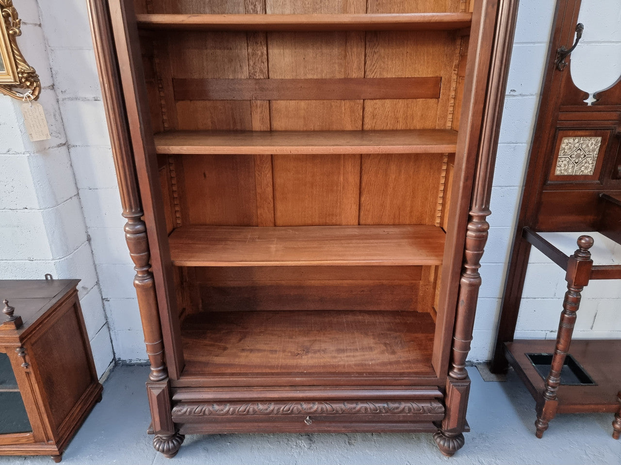 Henry II style 19th century walnut open bookcase with drawer which was originally an armoire now converted to a bookcase. It comes with four adjustable shelves. Is in good detailed condition.